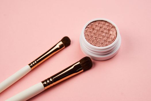 eyeshadow makeup brushes collection professional cosmetics accessories on pink background. High quality photo