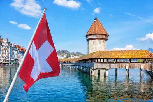 Panoramic view of city center of Lucerne with famous Chapel Bridge and lake Lucerne with Swiss flag, Switzerland