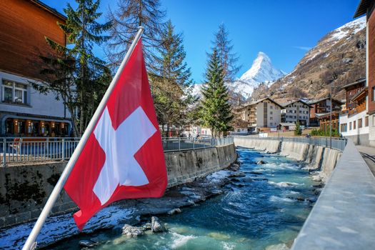 Beautiful View of Zermatt village and Matterhorn, with Swiss flag, Switzerland.