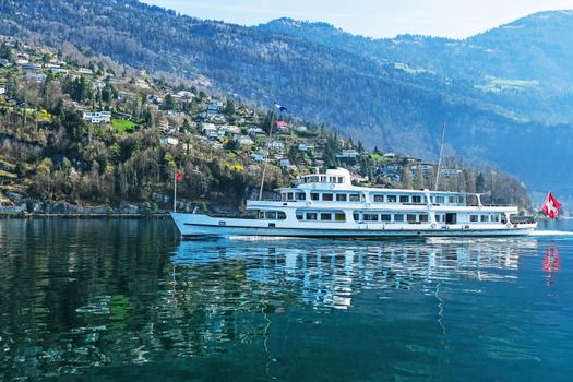 Tourist ferry boat taking passengers across the majestic and beautiful Lake Lucerne in Switzerland.