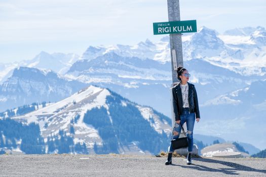 Young woman on Rigi mountain in Switzerland with a magnificent panoramic view of Swiss alps