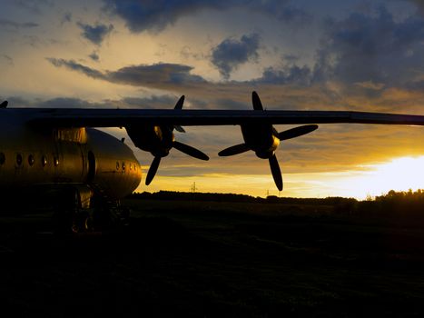 old Soviet military airplane, sunset time. Abandoned Historic Aircraft. Close up of propeller engine. Copy space