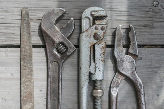 Standard plumbing and household tool kit consisting of wrenches, pliers and a file