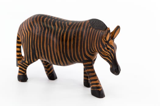A wooden figure of a zebra on white background