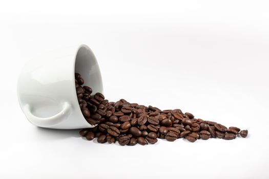A White cup with coffee beans on white background