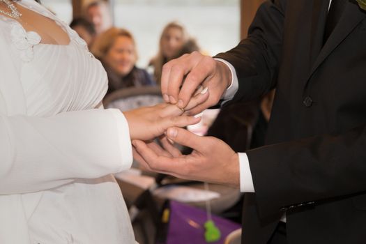 The bridal couple exchanges the wedding rings with each other