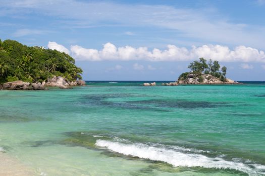 Beautiful beach with a small island in the near, Seychelles