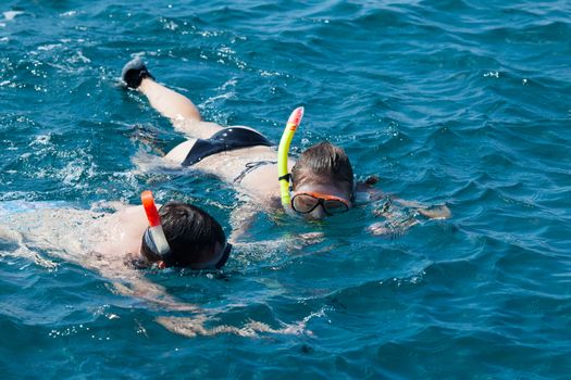 A couple snorkeling in the water