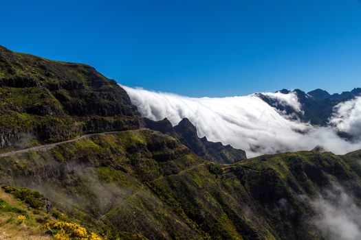 Clouds like a waterfall comes over the hills