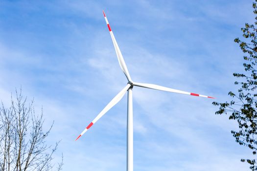 A Wind turbine with a blue sky in the background