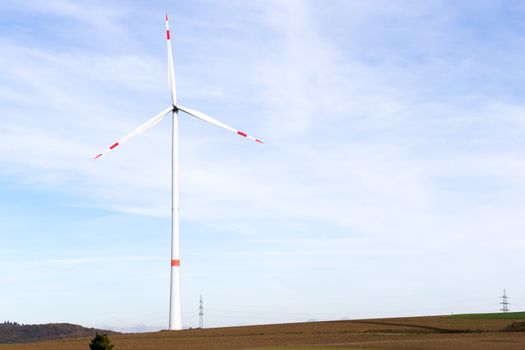 The windmill on a field with blue sky