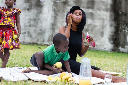 happy family at the park picnicking and playing together