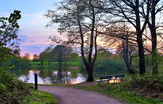 Beautiful sunset landscape at a lake with a reflective water surface.