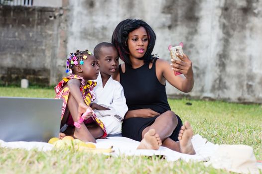 young mother takes photos with her children in the park