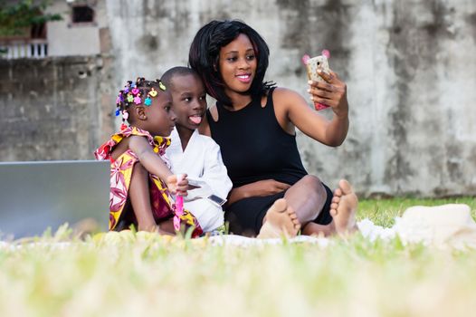 young mother takes photos with her children in the park