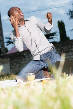 Happy emotional man speaks on the phone and expresses his emotions while receiving good news