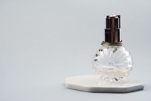 Bottle with aromatic liquid perfume cologne light background. High quality photo