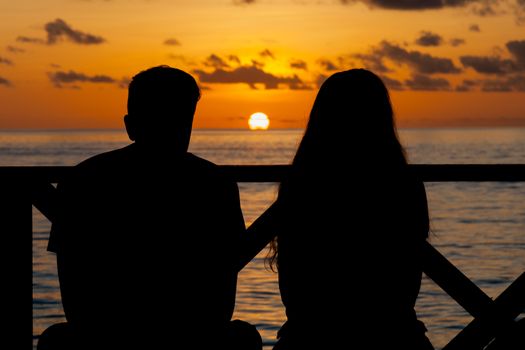 Sunset on the Maldives, a couple on the beach looking in the distance