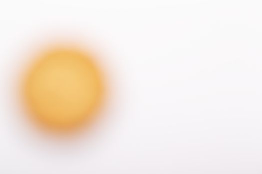 A Yellow blurred circle on a white background