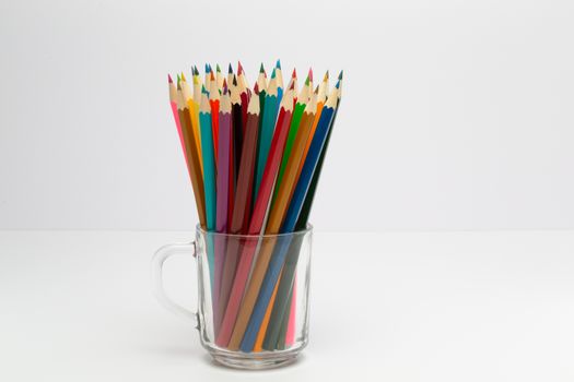Some colorful wooden pencils on a white background
