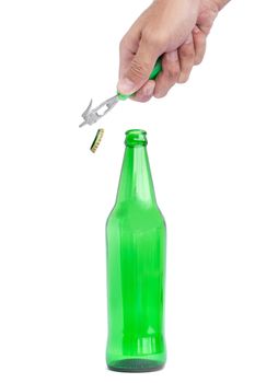 Hands are opening a beer bottle with a device for opening the bottle.