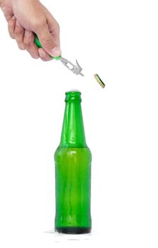 Hands are opening a beer bottle with a device for opening the bottle.