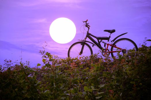 Closeup of the mountain bike with a colorful sky and sunset, vintage tone filter for poster or postcard.