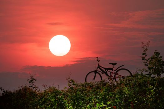 Closeup of the mountain bike with a colorful sky and sunset, vintage tone filter for poster or postcard.