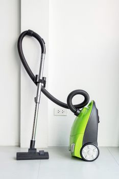 Colorful of electric vacuum cleaner in the white room.