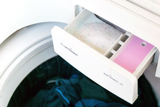 Closeup of the detergent and fabric softener in the washing machine.