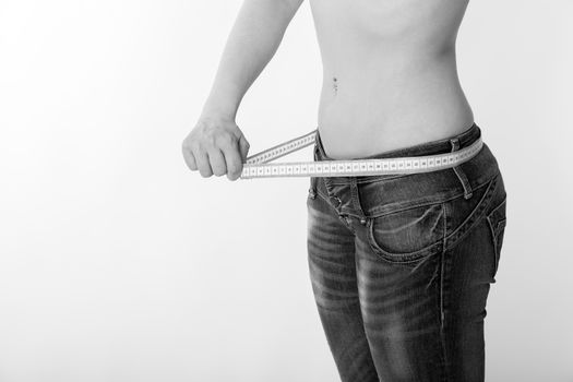 woman in jeans with a tape measure
