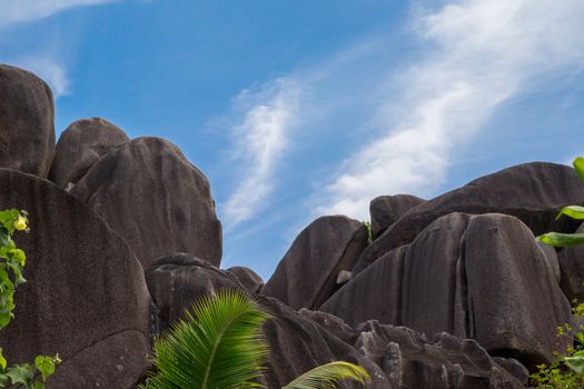 Blue sky with some clouds and big stones in front