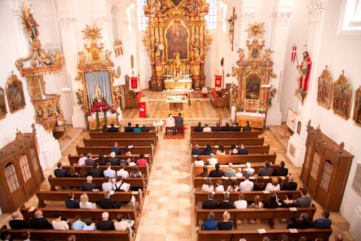 Wedding ceremony in a church with the newlyweds and guests