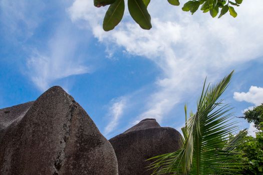 Blue sky with some clouds and big stones in front