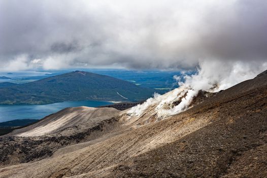 Lake Rotoaira seen from steaming volcanic slope of Mt. Tongariro on Tongariro Crossing national park. North Island, New Zealand