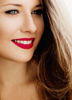 Attractive woman smiling, brunette with long light brown hair, girl wearing natural makeup look, female showing healthy white teeth, beauty portrait for cosmetic or lifestyle brands