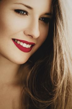 Attractive woman smiling, brunette with long light brown hair, girl wearing natural makeup look, female showing healthy white teeth, beauty portrait for cosmetic or lifestyle brands