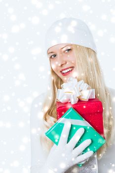 Christmas surprise and glitter snow background, happy blonde girl with gift boxes in winter season for shopping sale and holiday brands