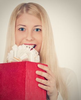 Blonde girl with gift boxes in Christmas, woman and presents in winter season for shopping sale and holiday brands