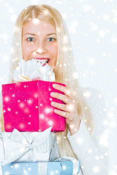Christmas and glitter snow background, happy blonde girl with gift boxes in winter season for shopping sale and holiday brands