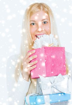 Happy Christmas and glitter snow background, happy blonde girl with gift boxes in winter season for shopping sale and holiday brands