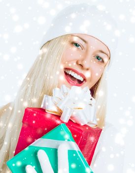 Merry Christmas and glitter snow background, happy blonde girl with gift boxes in winter season for shopping sale and holiday brands