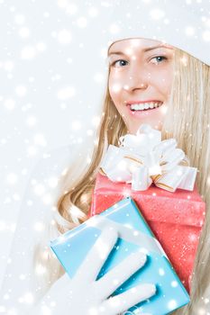 Merry Christmas and glitter snow background, happy blonde girl with gift boxes in winter season for shopping sale and holiday brands