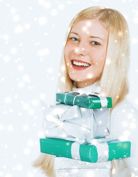 Merry Christmas and glitter snow background, happy blonde girl with gift boxes in winter season for shopping sale and holiday brands