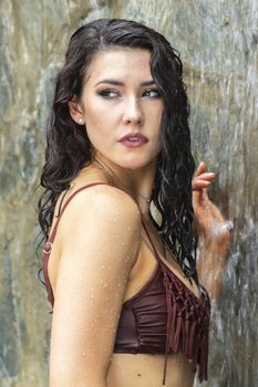 A gorgeous brunette model enjoys a day at the pool on a Caribbean island