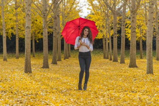 A beautiful brunette model with yellow fall foliage