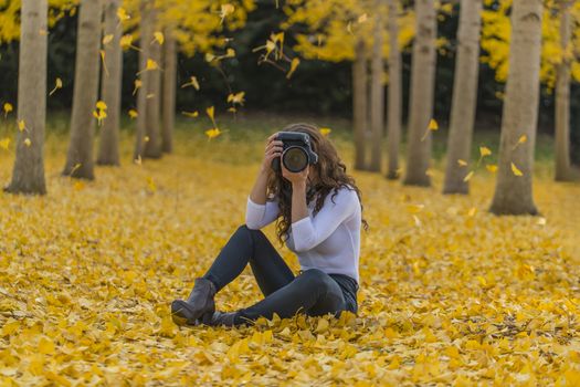 A beautiful brunette model with yellow fall foliage