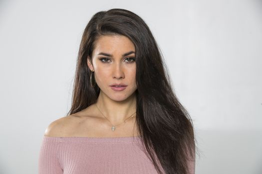 A gorgeous brunette model posing in a studio environment