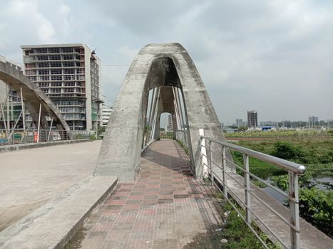 stylish steel and concrete bridge on lake