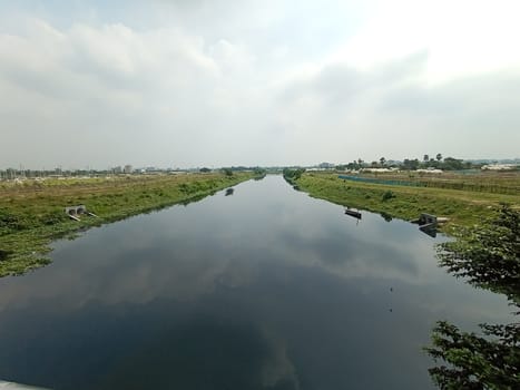 river and green view with sky and water